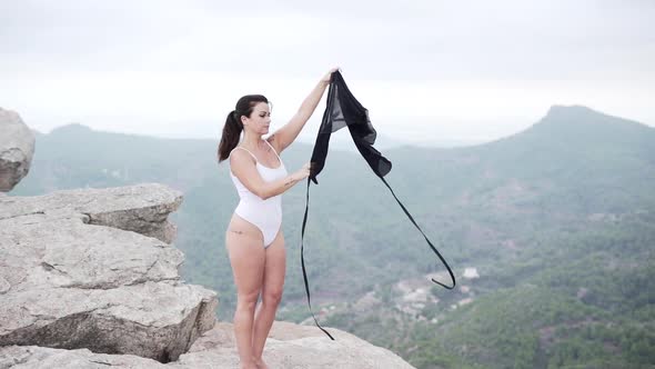 Female dancer taking off skirt in nature