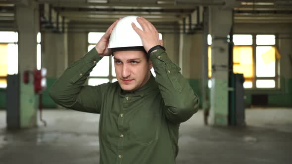 An Engineer in a White Helmet Shows a Thumb Up