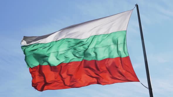 Bulgarian Flag Waving in Strong Wind Against Blue Cloudy Sky