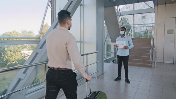 Afro American Assistant Wears Medical Face Mask Stands in Airport Terminal Holding Welcome Sign