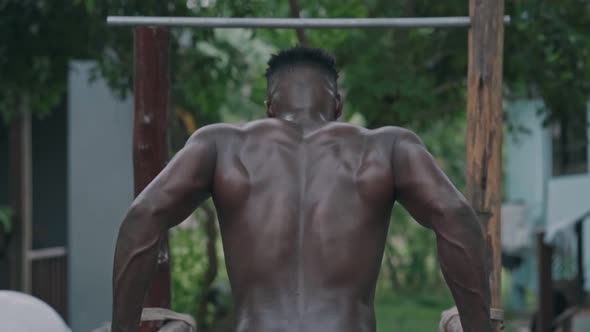 Young African American Fit Man Doing Dips on Parallel Bars