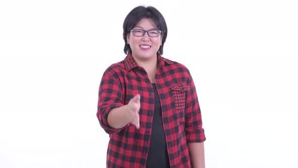 Happy Overweight Asian Hipster Woman Giving Handshake