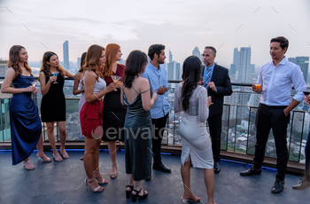 invited his team to join the party on the rooftop restaurant they hold a glass of drink wine, ora