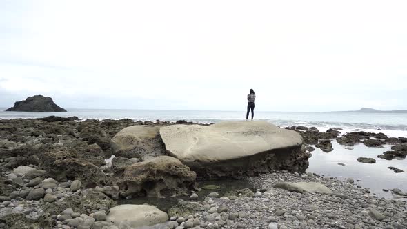 Female traveler taking photo at seaside