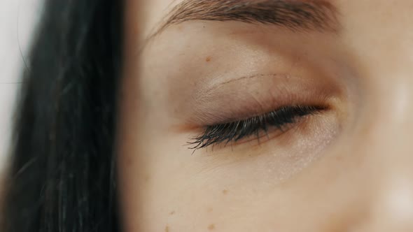 Close-up of Female Eye Opening with Beautiful Blue Iris