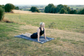 Young woman with blond hair practicing yoga outdoors. - PhotoDune Item for Sale