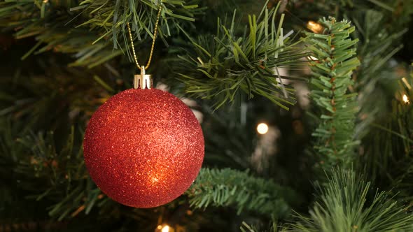Glittering  ornament hanged on Christmas tree 4K 2160p 30fps UltraHD footage - Red color bauble on t