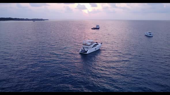 Aerial drone view seascape of tranquil island beach trip by blue ocean and bright sandy background o