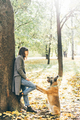 Woman walking with dog in sunny autumn park. - PhotoDune Item for Sale