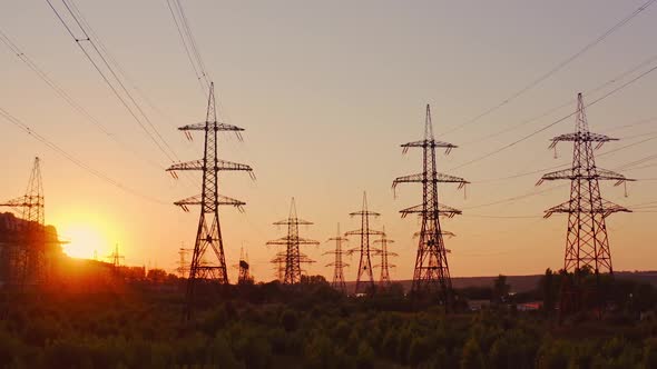 High voltage electric towers at sunset. Transmission power line. 