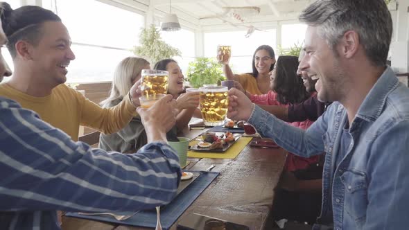 Multicultural People Having Breakfast Drinking Coffee and Cheers Beer