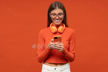 ones around neck using smartphone app, downloading music on orange background