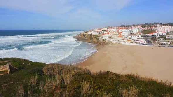 Aerial Drone View of Sandy Beach at Lisbon, Portugal at Praia das Macas, a Beautiful Coastal Town on