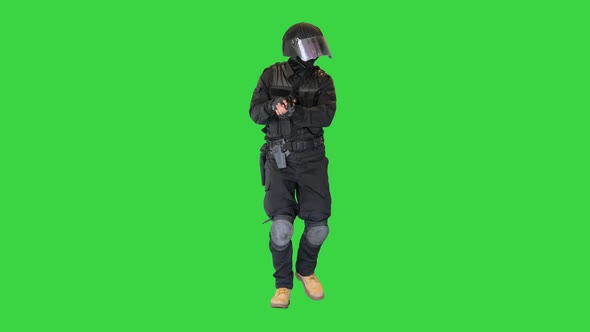 Anti Terrorist or Riot Unit Walking and Aiming with a Pistol on a Green Screen Chroma Key
