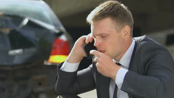 Stressed Male Taking Pill Feeling Nervous After Auto Accident, Talking on Phone