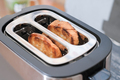 two ready toasts in a toaster. ready crusty bread for morning sandwiches. close up view - PhotoDune Item for Sale
