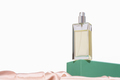 a bottle of perfume on green podium and with silk background. luxury fragrances for women. - PhotoDune Item for Sale