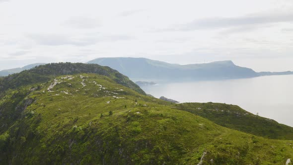 Green Landscape On The Clifftop Surrounded With Calm Waterscape In Maaloy Town In Vestland County, N