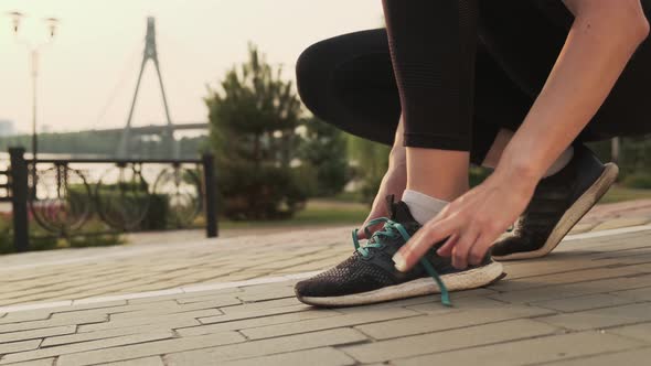 Female Sport Fitness Runner Getting Ready for Jogging Outdoors on Way