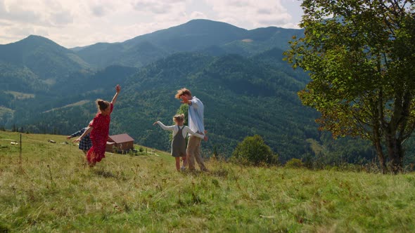 Playful Family Playing Running Like Planes on Meadow