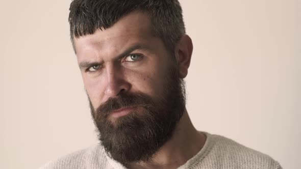 Serious Man Face Close Up. Portrait of Handsome Bearded Young Guy Looking at Camera.