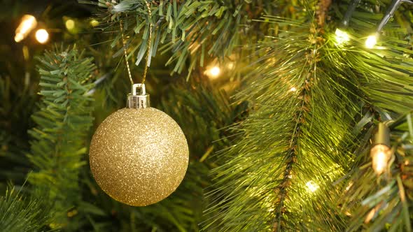 Golden round ornament close-up 4K 2160p 30fps UltraHD footage - Gold color bauble on the Christmas  