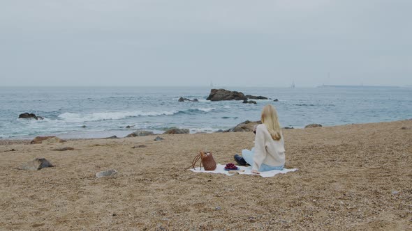 Woman Is Sitting On Beach