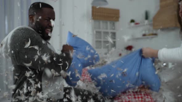 Happy Diverse Couple Having Fun Fighting at Home