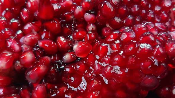 Super Close Up of Ripe Pomegranate Grains Falling Down with Juice