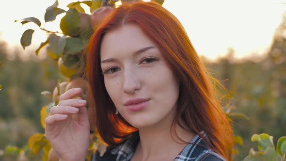 Portrait of Redhead Woman on Nature