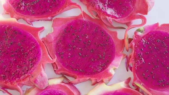 A rotating backdrop made from purple slices of dragonfruit.