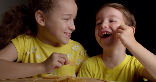 Cute Little Funny Kids Boy and Girl Eat Potato Chips Kids Take Chips and Have Fun Kids Eat at the