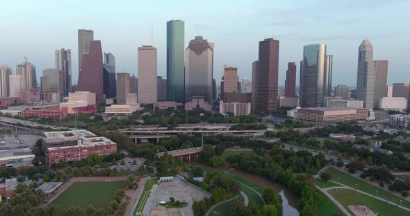 Tracking aerial shot of downtown Houston in the evening