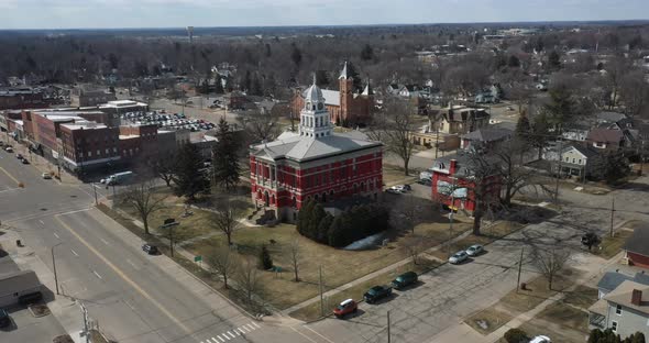 Historic Eaton County courthouse in Charlotte, Michigan with drone flying over side.