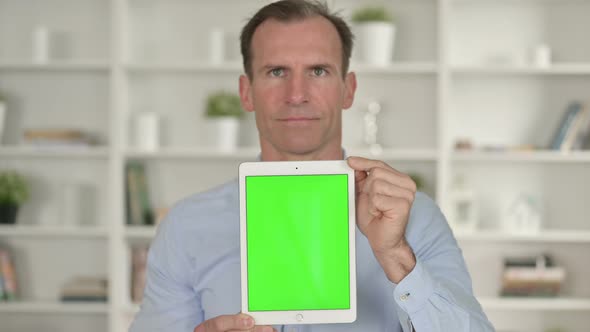 Portrait of Middle Age Businessman Holding Tablet with Chroma Screen 