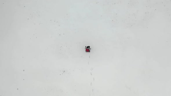 Top View of a Human Walking By the Snow Field.