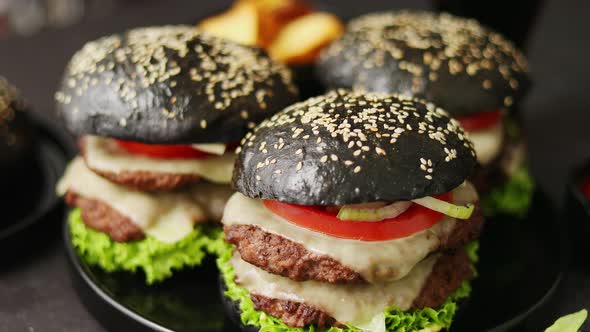 Delicious Black Hamburger with Patties and Cheese