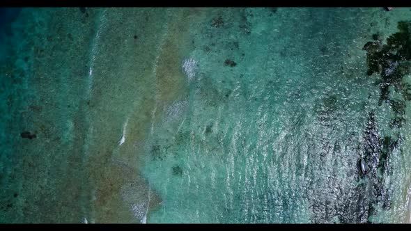 Aerial abstract of idyllic seashore beach lifestyle by blue ocean with bright sand background of a d