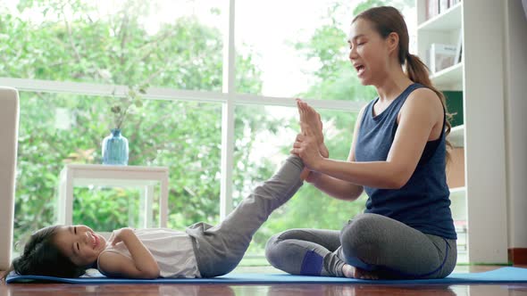 Asian Mother Practicing Yoga With Her Daughter 06