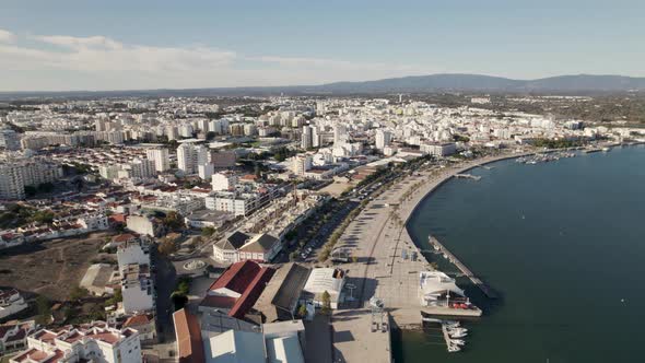 Promenade with palm trees. Panoramic view of Portimao cityscape, Algarve. Portugal