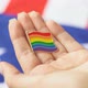 Young woman holding LGBT icon in her hand. American flag on the background. - VideoHive Item for Sale