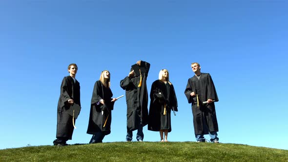 Graduates throw caps into air