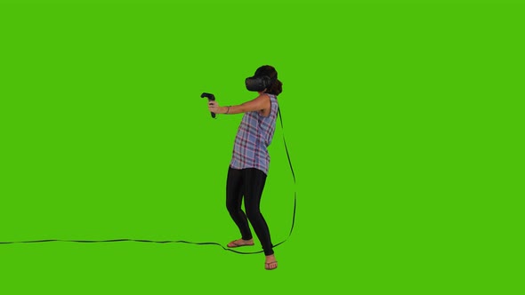 Playing in A Vr Video Game by A Young Woman Over a Green Screen