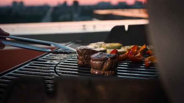 BBQ close-up: filet mignon steak and grilled vegetables cooking