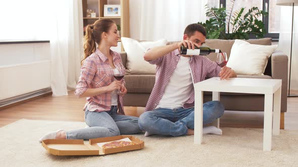 Couple with Wine and Takeaway Pizza at Home