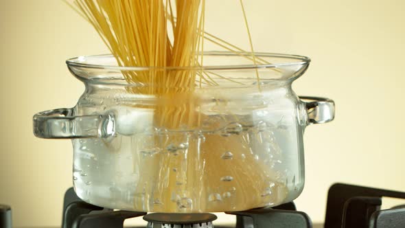 Super Slow Motion Shot of Fresh Spaghetti Falling Into Boiling Salted Water at 1000 Fps