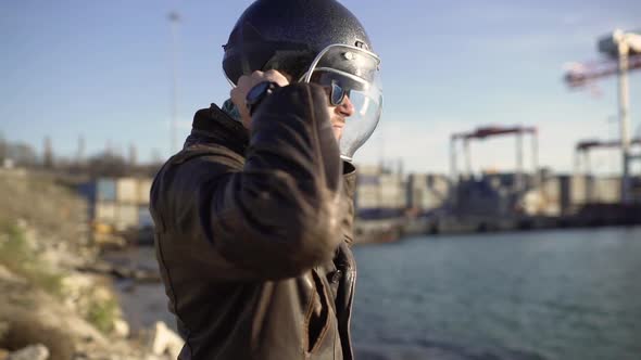 a Man Motorcyclist Wears a Helmet and Ride on His Motorcycle