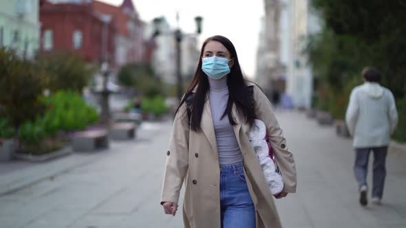 Women Walking in Medical Mask with Toilet Paper During the Second Wave Quarantine Coronavirus COVID