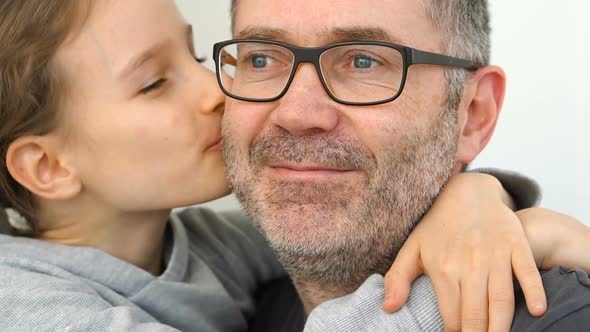 Family Portrait of Senior Father and Little Blond Daughters are Hugging Indoors and Smiling Fathers