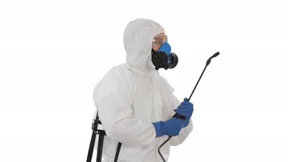 Disinfection For Virus Killing Worker in Hazmat Suit and Face Protection Mask Spraying Using